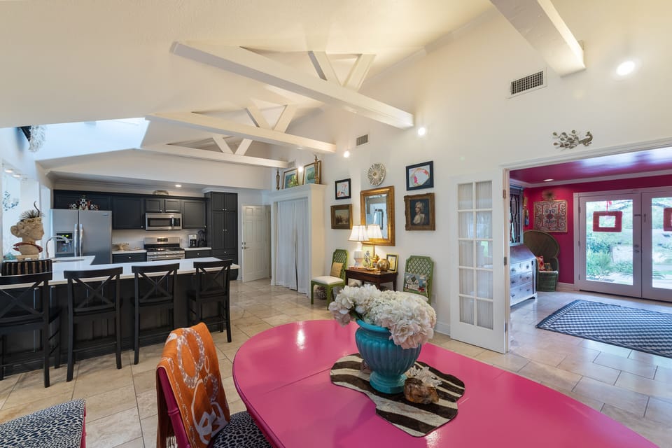 Dining area looking into kitchen and out front door 