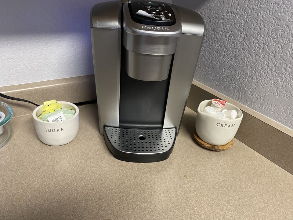 Keurig coffee maker.  Coffee and tea pods provided along with sugar and cream.
