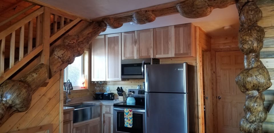 The kitchen with the burl-wood accent on  ceiling and stairs! 