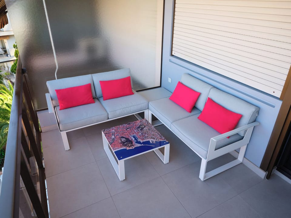 The balcony furniture, seating for 4 people and 2 coffee tables.