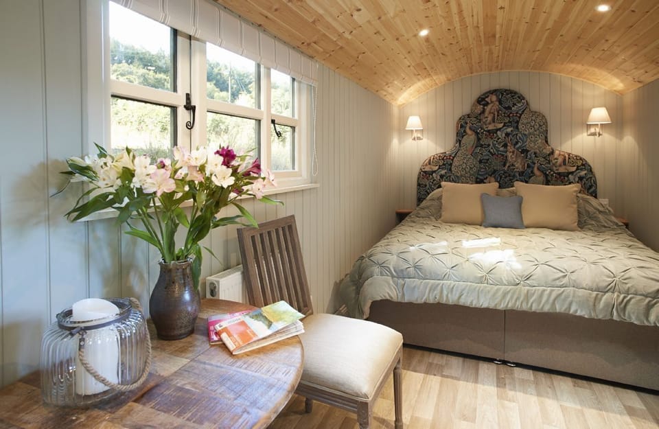 The main shepherd's hut with a super-king size bed, well appointed kitchen and dining area