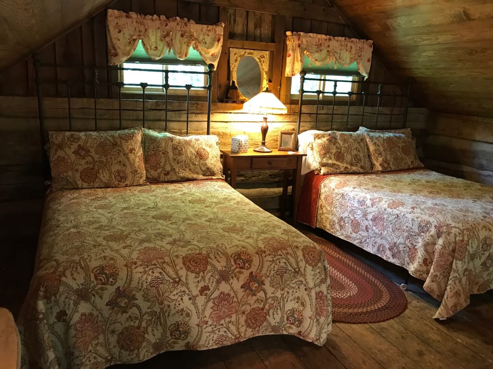 The sleeping room has two full beds and a twin bed, sleeping 5 comfortably 