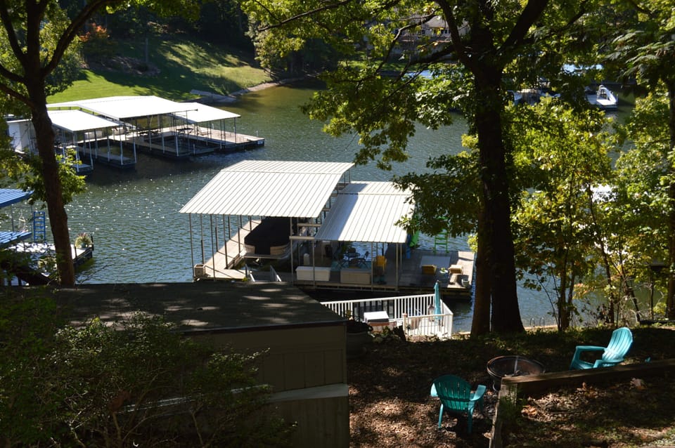 View from side of house of firepit, seating and dock