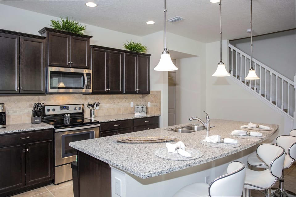 Fully equipped kitchen with modern appliances and a large island for family gatherings.