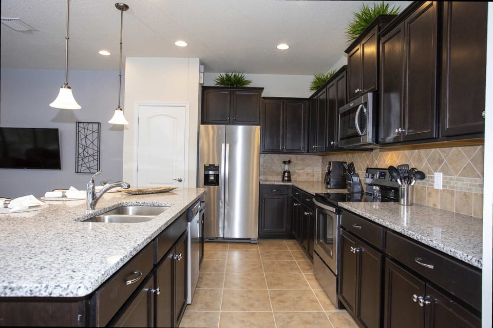 Fully Equipped Kitchen: Cook up family favorites in a chef-inspired kitchen with stainless steel appliances and granite countertops.
