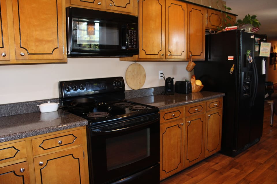 Kitchen with lots of counter space, microwave and side by side refrigerator 
