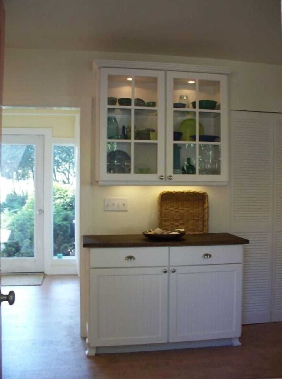 Looking from the kitchen to the front entrance and the bay, beyond.