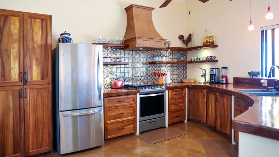 The large fully stocked kitchen with parota cabinets, stainless appliances.