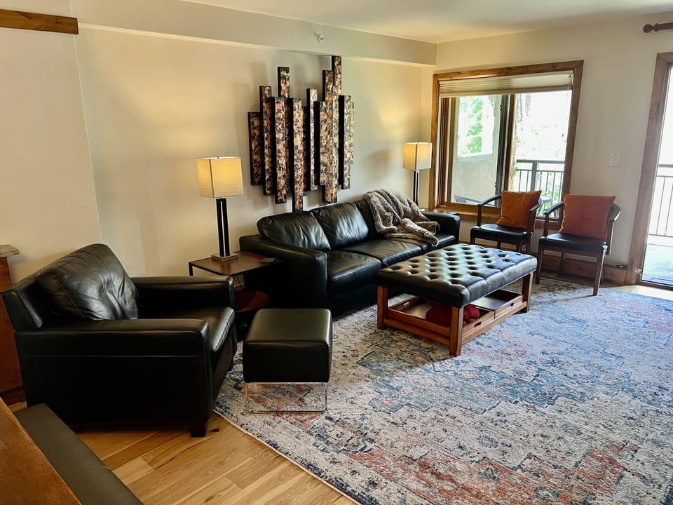 Living room with leather sleeper couch and gas fireplace