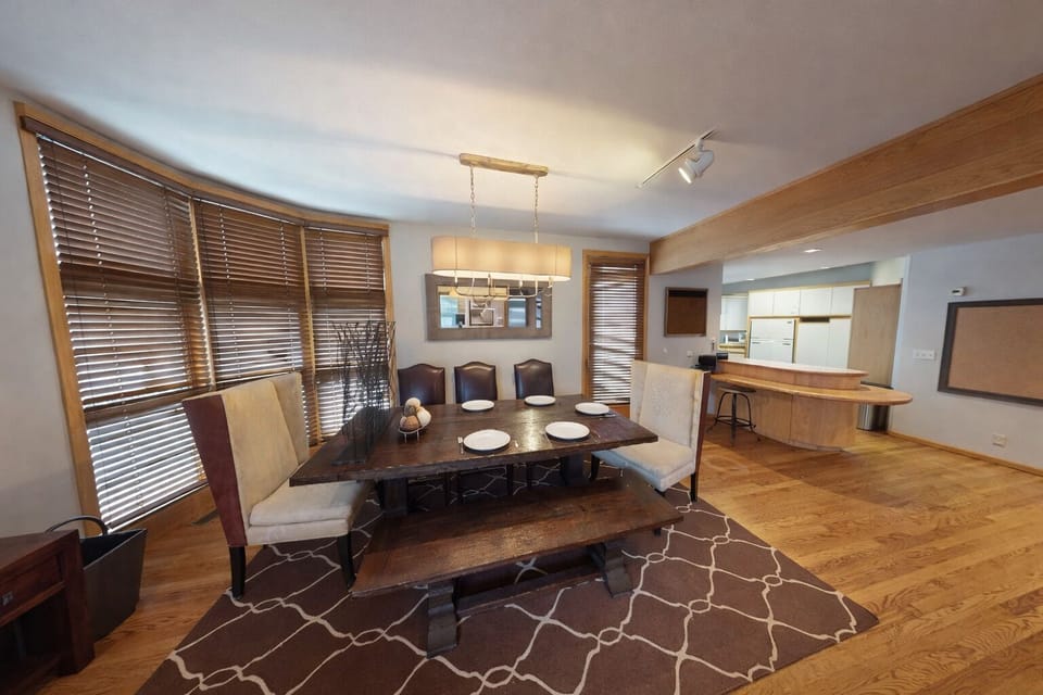 Gather around your elegant dining table for memorable meals together, with warm wood touches and open kitchen nearby for easy entertaining.