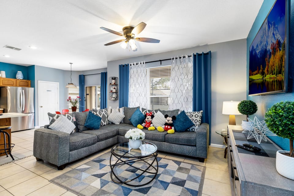 Stunning family room with sleeper sofa plus 62" smart TV. with pool view.