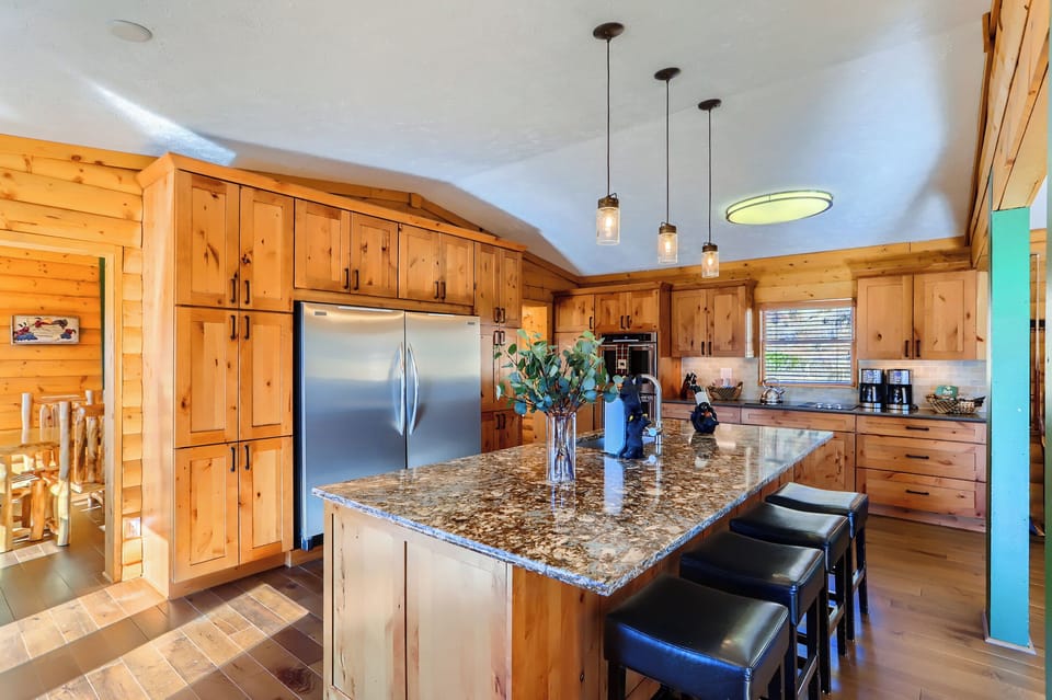 Kitchen with large island, full size freezer and full size refrigerator, double ovens, extra large glass cooktop, 2 dishwashers