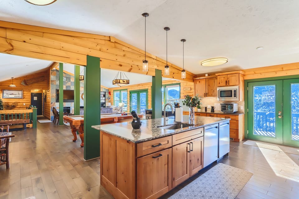Kitchen, pool table, living room with smart tv. Main deck off of this area