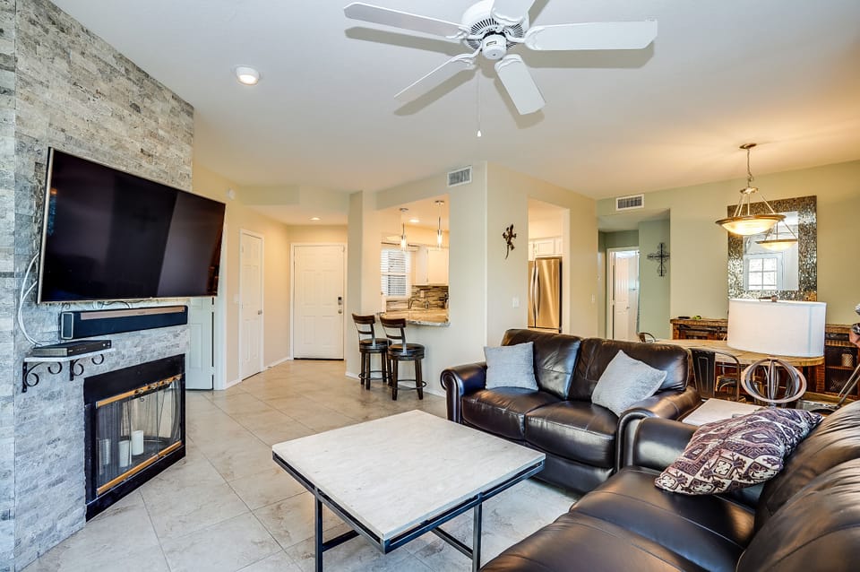 Living area with leather seating, throw blanket and comfy pillows