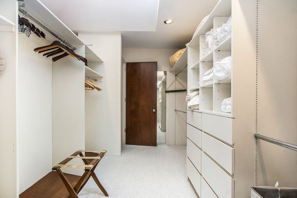 Master closet with plenty of extra linens.