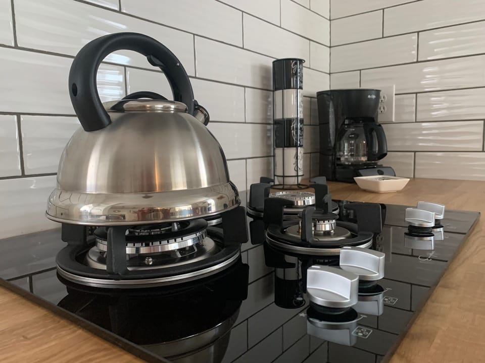 Tea kettle, coffee pot & mugs for your use.