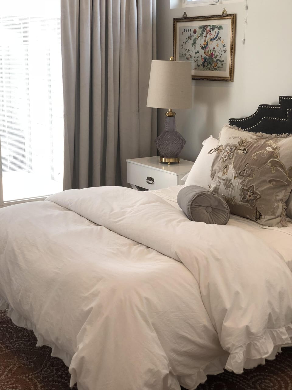 Master bedroom with luxurious, comfy bed, with French doors out to private patio