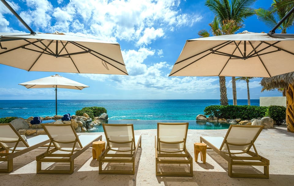 Sun loungers facing the infinity pool and ocean at Casa Edwards Too, Punta Bella, Los Cabos.