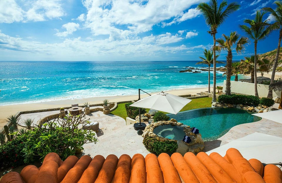 Elevated view of the pool,jacuzzi, and private beach access of the vacation villa in Cabo.