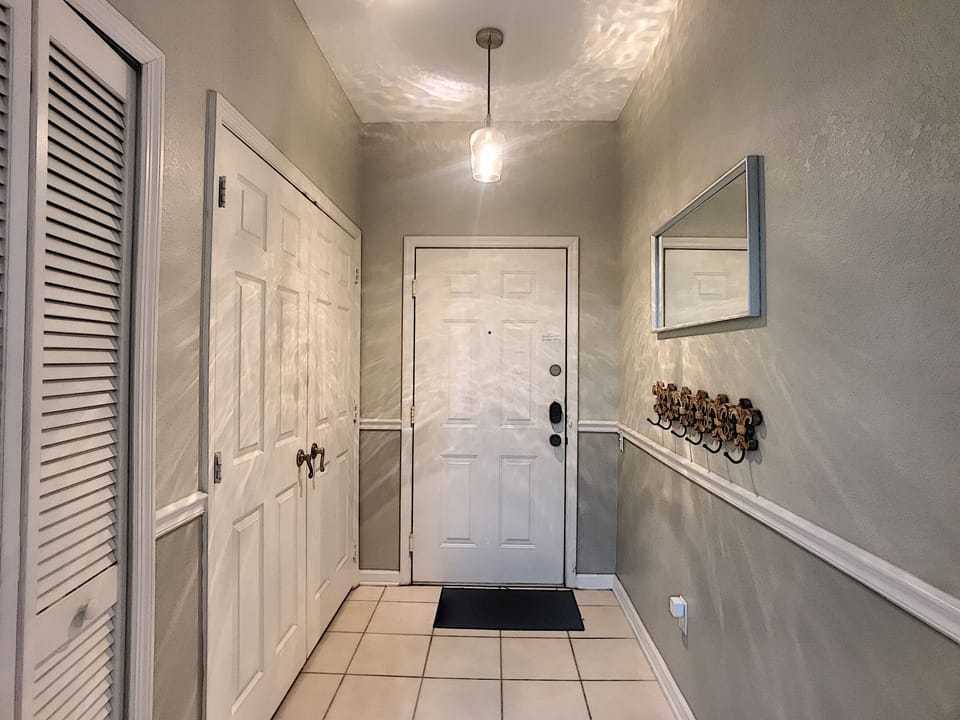 Entryway with washer and dryer in closet to the left