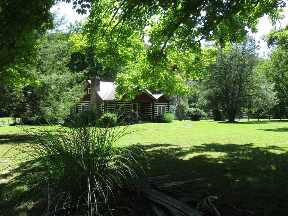 Historic 100-year old log cabin on farm