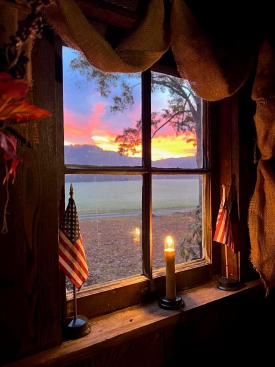 Early morning sunrise through the window of our historic cabin