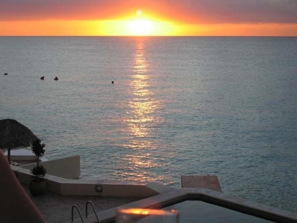 Watch sunset sipping cocktail