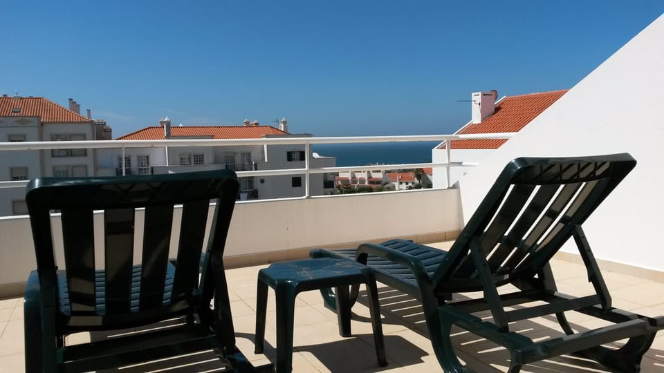 roof terrace with sun loungers and sea views