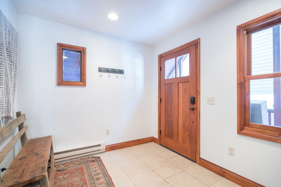 Spacious entryway with bench and gear hooks