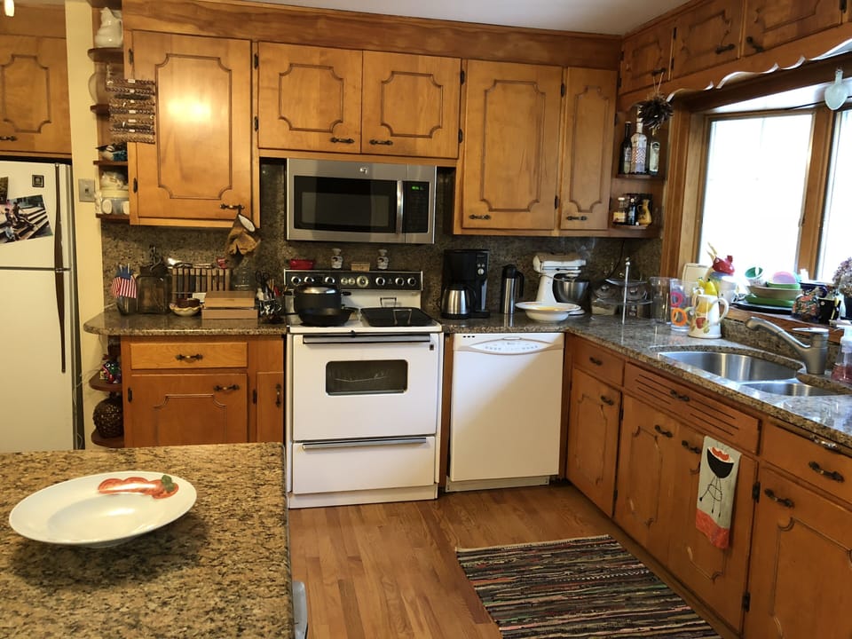 Kitchen with dishwasher, oven, microwave, and refrigerator