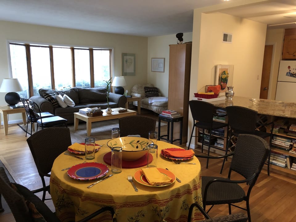 Living room with dining area and open kitchen with bar seats