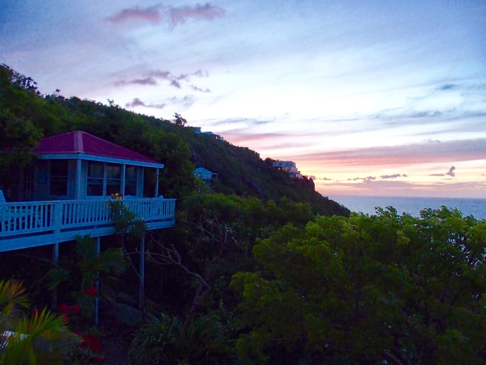 Deck and cottage with sunset in background