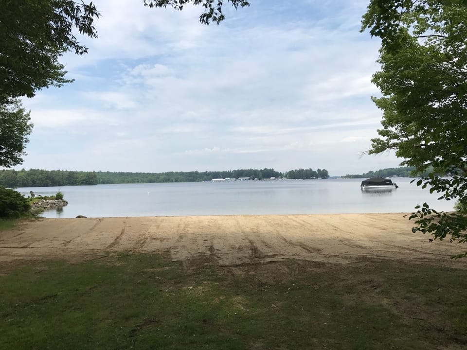Sandy walk out shared beach directly across from home divided by private road. 