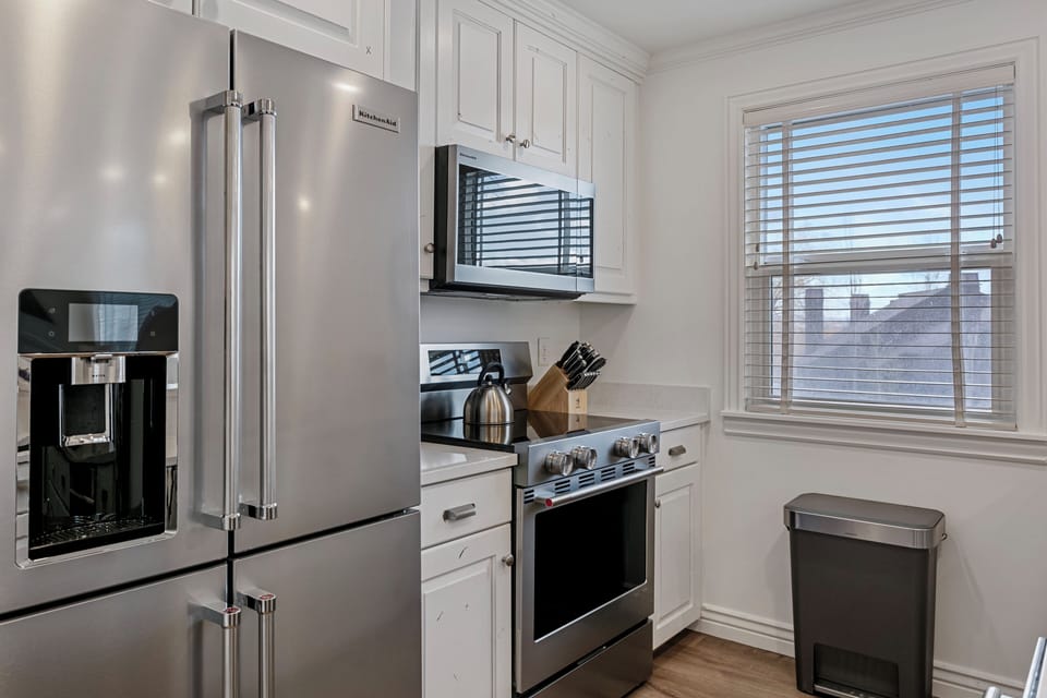 Three Kings 83 kitchen with stainless appliances and bright white cabinetry 