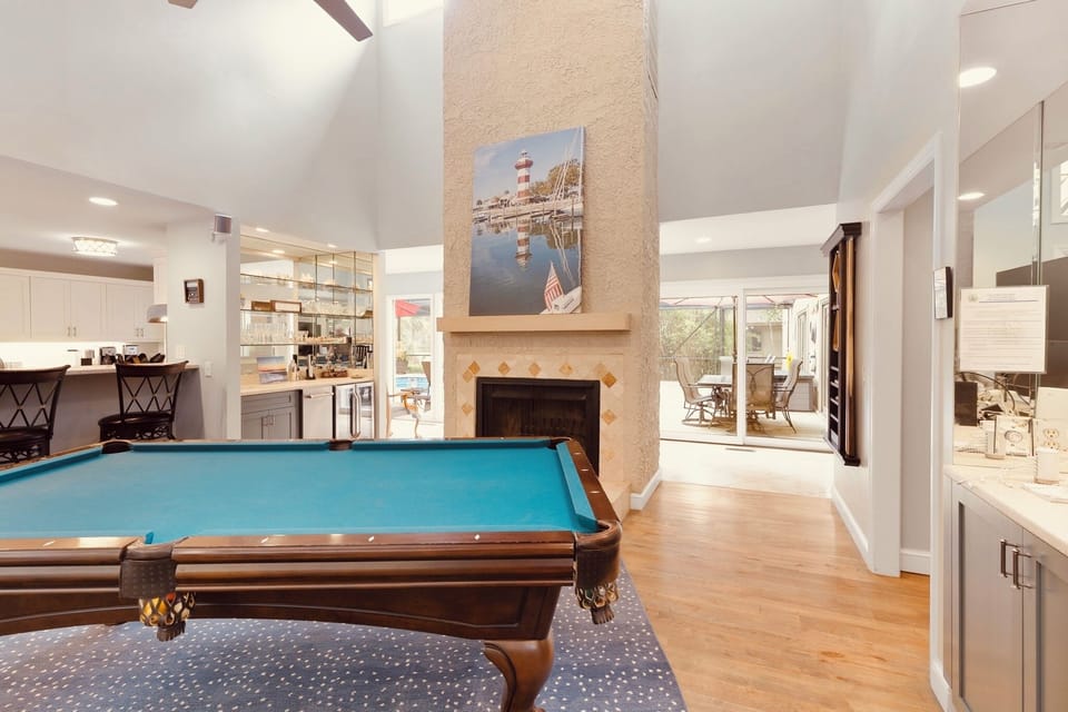 The billiard room has a full sized pool table & a 65" 4K TV along with a wet bar with ice maker & wine fridge. Great space to watch a game while playing a game of pool.