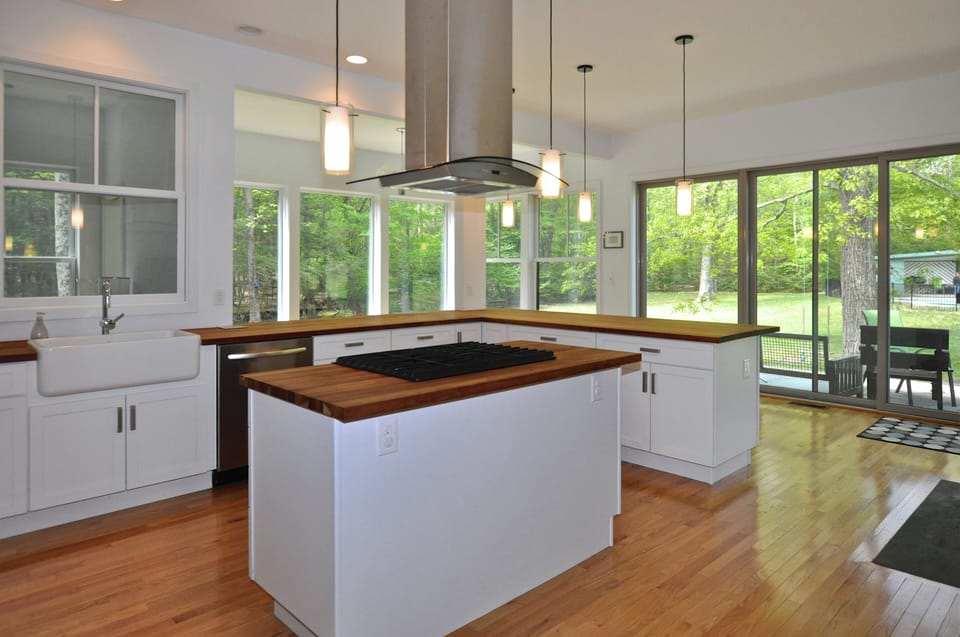 The kitchen - farm sink, gas cooktop, lots of cherry butcherblock countertops

