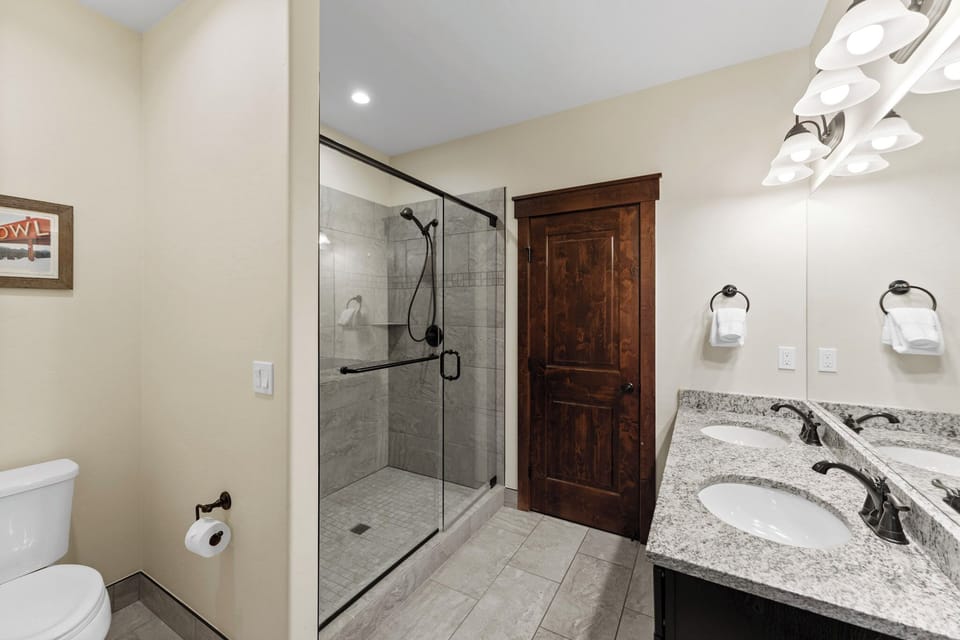 Refresh in your spacious bathroom with a luxurious walk-in shower, granite vanity, and modern amenities designed for comfort.