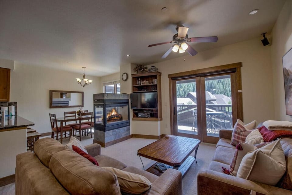 The double sided fireplace provides a warm glow to both the seating and dining areas.