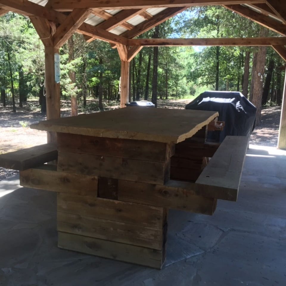 Picnic table built by Bobby.  The top is a huge 2" rock out of his rock quarry. 
