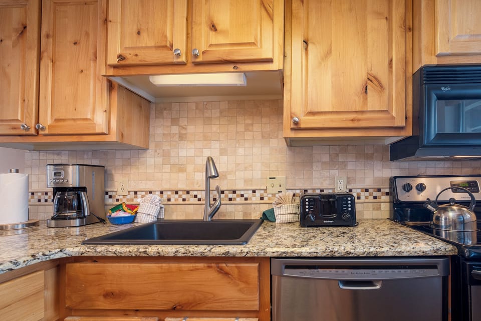 Your fully equipped kitchen features warm wood cabinets, granite countertops, and everything you need to prepare memorable meals during your stay.