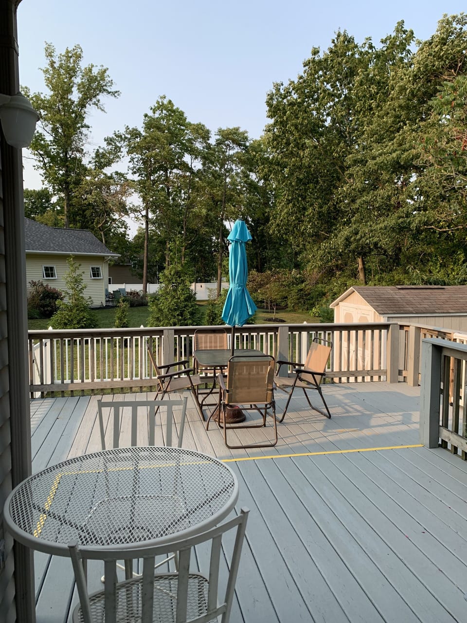 Table with umbrella and bistro table on deck