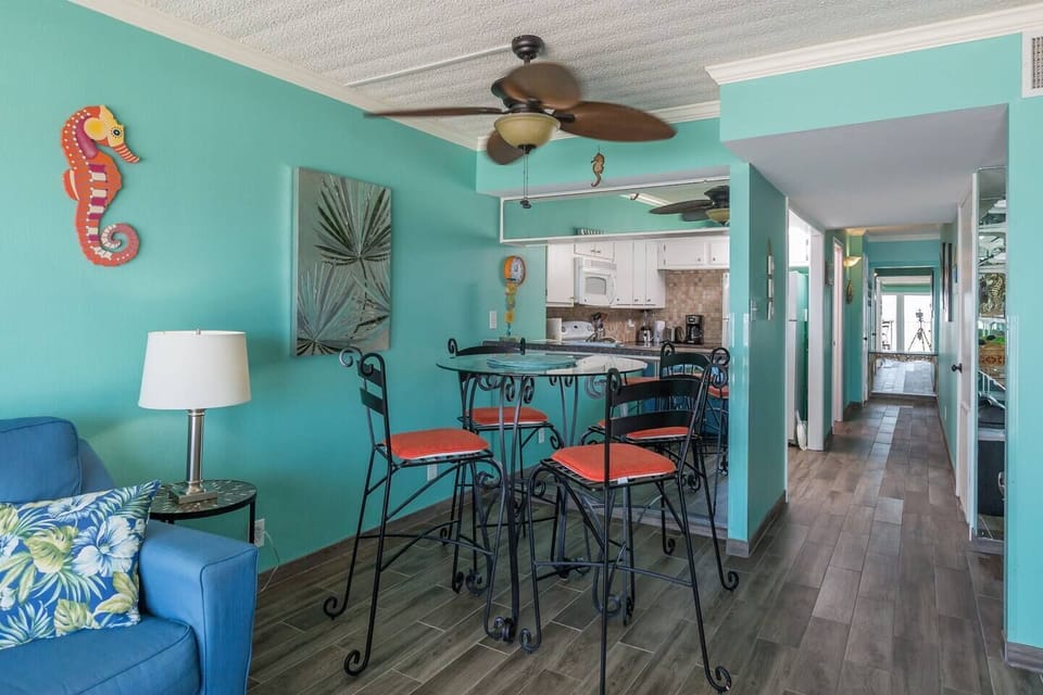 Bar height dining table with a Gulf Front view