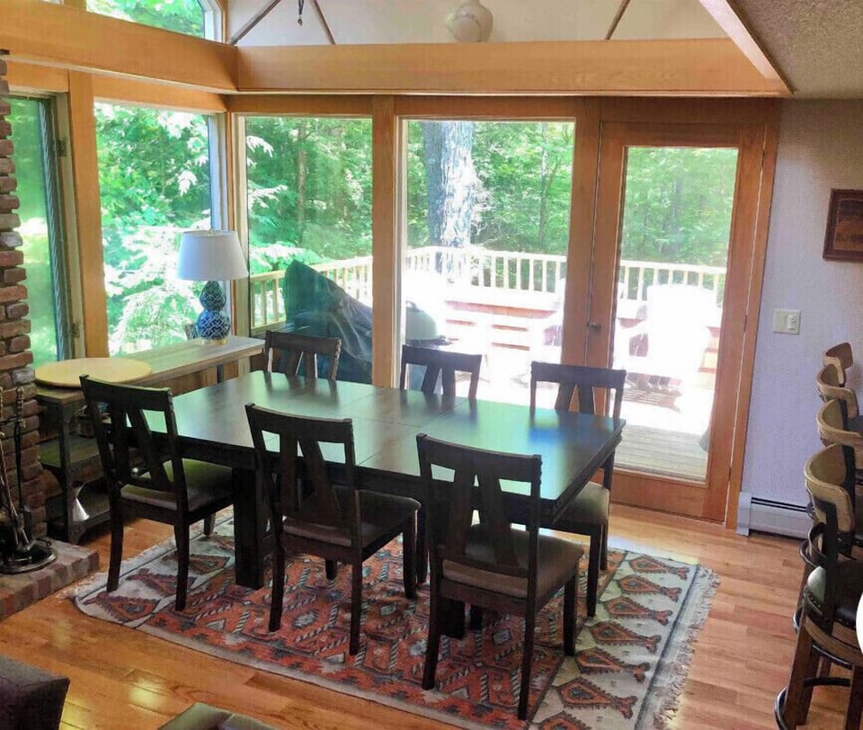 Expandable dining table with access to deck