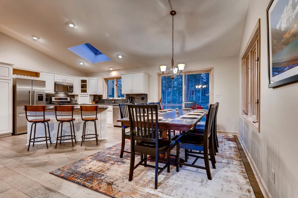 Large, 10 person dining table with additional seating at the island