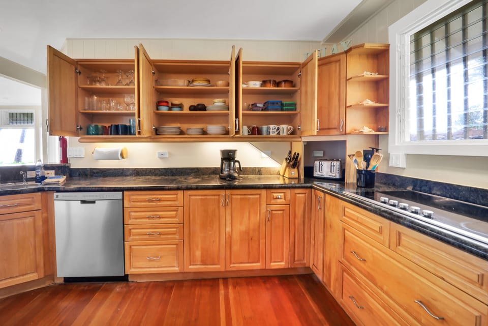 Fully equipped kitchen with oven, stovetop, microwave, dishwasher, coffee maker