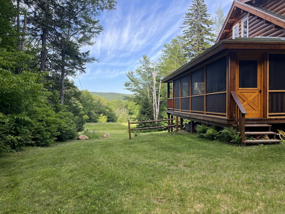 Cabin view of field and ridge line. Enjoy stream sounds from the screened porch.