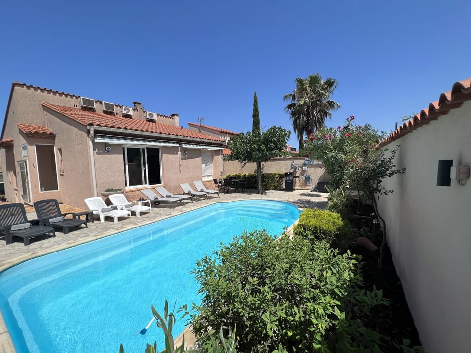 REAR VIEW OF VILLA WITH SUN SHADES