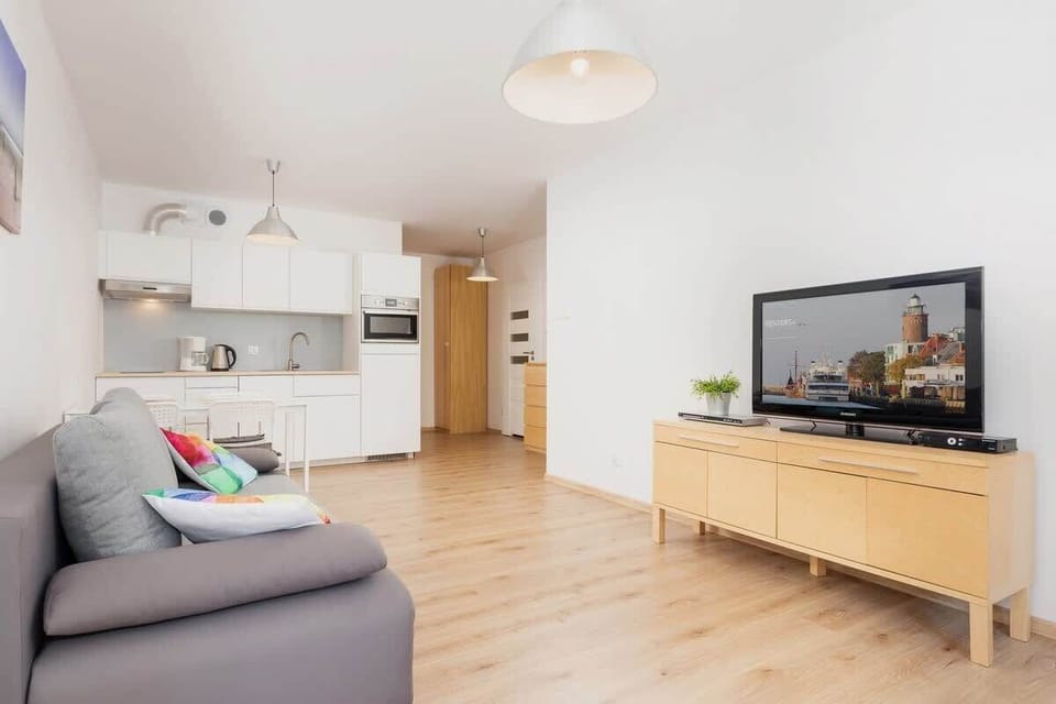 Bright living room space combined with kitchenette.
