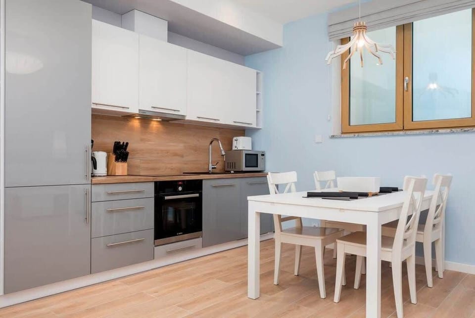 Kitchenette with oven and refrigerator. 