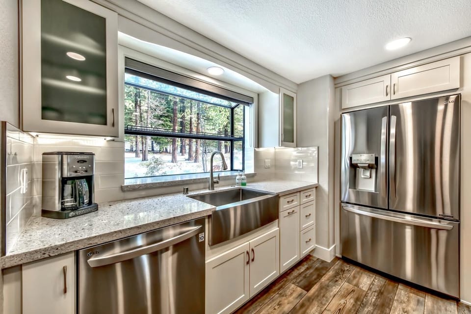 Your gourmet kitchen awaits with granite counters, stainless appliances, and forest views from the window above your prep sink.